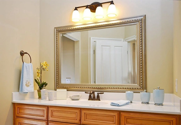 Bathroom with a big mirror and cute decorations.