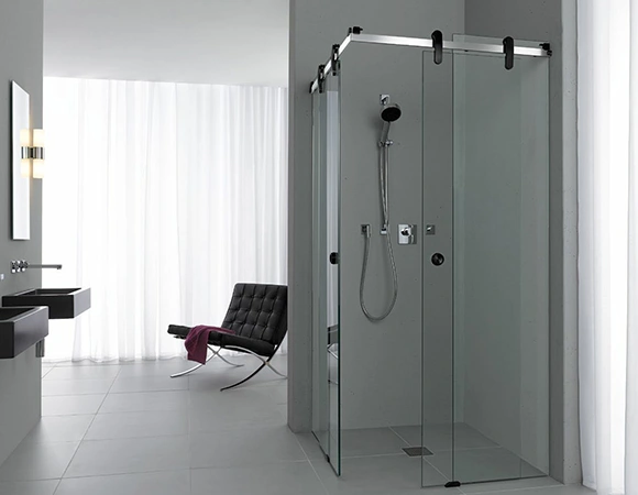 Bathroom with glass shower and minimalist decor.