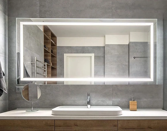 Modern bathroom with a sleek illuminated mirror.