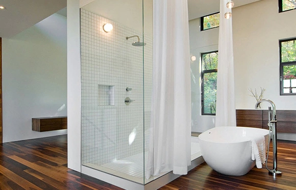 Residential bathroom with an elegant shower door and a bathtub.